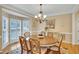 Elegant dining room with a wood table, chandelier, and lots of light at 1355 Zephyr Ct, Cumming, GA 30041