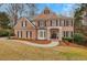 Charming brick two-story home with a well-manicured lawn and inviting front entrance at 1355 Zephyr Ct, Cumming, GA 30041