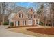 Beautiful two-story brick home with black shutters and well-maintained landscaping at 1355 Zephyr Ct, Cumming, GA 30041