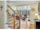 Bright foyer with hardwood floors, staircase, and view into the living room at 1355 Zephyr Ct, Cumming, GA 30041