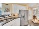 Kitchen featuring stainless steel appliances, granite countertops, and white cabinets for a sleek design at 1355 Zephyr Ct, Cumming, GA 30041