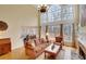 Bright living room featuring a two-story window, fireplace, and hardwood floors at 1355 Zephyr Ct, Cumming, GA 30041