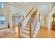 Inviting staircase with hardwood floors, light walls, and natural light enhancing its appeal at 1355 Zephyr Ct, Cumming, GA 30041