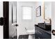 Stylish powder room featuring black and white geometric tile flooring, modern fixtures, and elegant design at 2047 Seavey Dr, Decatur, GA 30032