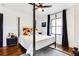 Bedroom featuring four-poster bed, modern ceiling fan, hardwood floors and natural light from the window at 2047 Seavey Dr, Decatur, GA 30032