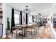 Open-concept dining room and living room featuring modern light fixture and hardwood floors at 2047 Seavey Dr, Decatur, GA 30032