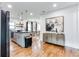 Open concept kitchen featuring hardwood floors, gray cabinets, stainless appliances, and modern pendant lighting at 2047 Seavey Dr, Decatur, GA 30032