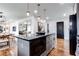 Spacious kitchen featuring gray cabinets, an island with bar seating, and stainless appliances at 2047 Seavey Dr, Decatur, GA 30032