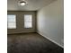 This bedroom features neutral walls, carpet flooring, and two windows at 225 Whirlwind Ct, Atlanta, GA 30349