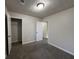 This bedroom features neutral walls, carpet flooring, and a closet and entry door at 225 Whirlwind Ct, Atlanta, GA 30349