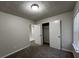 This bedroom features neutral walls, carpet flooring, a closet, and one window at 225 Whirlwind Ct, Atlanta, GA 30349