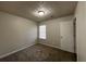 This bedroom has carpet, a window with blinds, and a door at 225 Whirlwind Ct, Atlanta, GA 30349