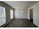 Dining room with modern chandelier and wood-look tile flooring, illuminated by natural light at 225 Whirlwind Ct, Atlanta, GA 30349