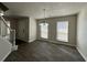 Dining area with modern chandelier, wood-look tile flooring and access to staircase and entryway at 225 Whirlwind Ct, Atlanta, GA 30349