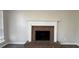 Traditional brick fireplace with decorative white mantle and wood look flooring at 225 Whirlwind Ct, Atlanta, GA 30349