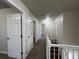 Second floor hallway featuring neutral paint, carpet and white trim throughout at 225 Whirlwind Ct, Atlanta, GA 30349