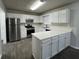 Modern kitchen featuring stainless steel appliances, quartz counters and white cabinets at 225 Whirlwind Ct, Atlanta, GA 30349