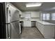 Bright kitchen features white cabinetry, stainless steel appliances and wood look flooring at 225 Whirlwind Ct, Atlanta, GA 30349