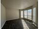 Spacious living room filled with sunlight from large windows and featuring stylish wood-look tile flooring at 225 Whirlwind Ct, Atlanta, GA 30349