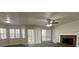 Spacious living room with fireplace, ceiling fan, wood look flooring and large windows at 225 Whirlwind Ct, Atlanta, GA 30349