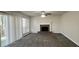 Spacious living room featuring wood look flooring, ceiling fan and brick fireplace at 225 Whirlwind Ct, Atlanta, GA 30349