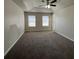 The main bedroom has two windows, carpet, and a ceiling fan with lighting fixture at 225 Whirlwind Ct, Atlanta, GA 30349