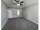 The main bedroom has carpet, a door, and a ceiling fan with a lighting fixture at 225 Whirlwind Ct, Atlanta, GA 30349