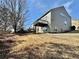 View of the back of the house with a backyard, a deck, and a trampoline at 3740 Crowchild Dr, Cumming, GA 30041