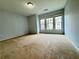 Spacious bedroom featuring plush carpeting, neutral paint, and an abundance of natural light at 3740 Crowchild Dr, Cumming, GA 30041