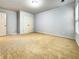 Empty carpeted bedroom featuring a double closet and adjacent door at 3740 Crowchild Dr, Cumming, GA 30041