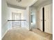 Upstairs hallway with carpet and open railing, leading to additional rooms in the home at 3740 Crowchild Dr, Cumming, GA 30041