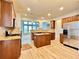 Bright kitchen with a central island, stainless appliances, and stone counters at 3740 Crowchild Dr, Cumming, GA 30041