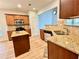 Kitchen featuring granite countertops, a breakfast bar, and hardwood floors at 3740 Crowchild Dr, Cumming, GA 30041