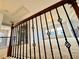 Upstairs loft area featuring decorative iron railing and plush carpeting at 3740 Crowchild Dr, Cumming, GA 30041