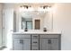 Stylish bathroom with gray cabinets, double sinks, quartz countertops, and modern black fixtures providing practical elegance at 409 Carrera Ln, Acworth, GA 30102