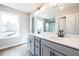 Well-lit bathroom featuring gray double vanity, marble countertops, sleek black faucets, and a window for natural light at 409 Carrera Ln, Acworth, GA 30102