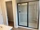 Bathroom featuring a glass shower with a built-in seat, sleek fixtures, and tiled walls at 409 Carrera Ln, Acworth, GA 30102