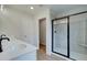 Bathroom featuring a double vanity with black fixtures and glass-enclosed shower at 409 Carrera Ln, Acworth, GA 30102