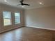 Bright bedroom with hardwood floors, a ceiling fan, recessed lighting, and a large window at 409 Carrera Ln, Acworth, GA 30102