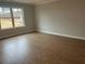 Bedroom featuring natural light from the large window and hard wood floors at 409 Carrera Ln, Acworth, GA 30102