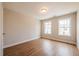 Bedroom featuring hardwood floors and two large windows at 409 Carrera Ln, Acworth, GA 30102