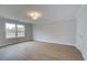 Sunlit bedroom with wood-look flooring, large windows, and neutral walls at 409 Carrera Ln, Acworth, GA 30102