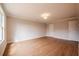 Bedroom showcases hardwood floors, neutral walls, white trim, recessed lighting, and natural light through a large window at 409 Carrera Ln, Acworth, GA 30102