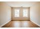 Bright bedroom featuring hardwood floors and two windows at 409 Carrera Ln, Acworth, GA 30102