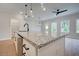 Bright kitchen island featuring granite countertops, sleek black faucet, and pendant lighting at 409 Carrera Ln, Acworth, GA 30102