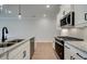 Modern kitchen featuring stainless steel appliances, granite countertops, and white cabinetry at 409 Carrera Ln, Acworth, GA 30102