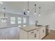 Kitchen island features a granite countertop, modern faucet, and a stainless steel dishwasher at 409 Carrera Ln, Acworth, GA 30102