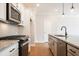 Modern kitchen with granite countertops, stainless steel appliances, white cabinets, and stylish pendant lights at 409 Carrera Ln, Acworth, GA 30102