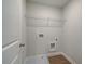 Convenient laundry room includes hookups, and overhead shelving at 409 Carrera Ln, Acworth, GA 30102