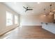 Spacious living room featuring hardwood floors, modern lighting, and a view of the front yard at 409 Carrera Ln, Acworth, GA 30102